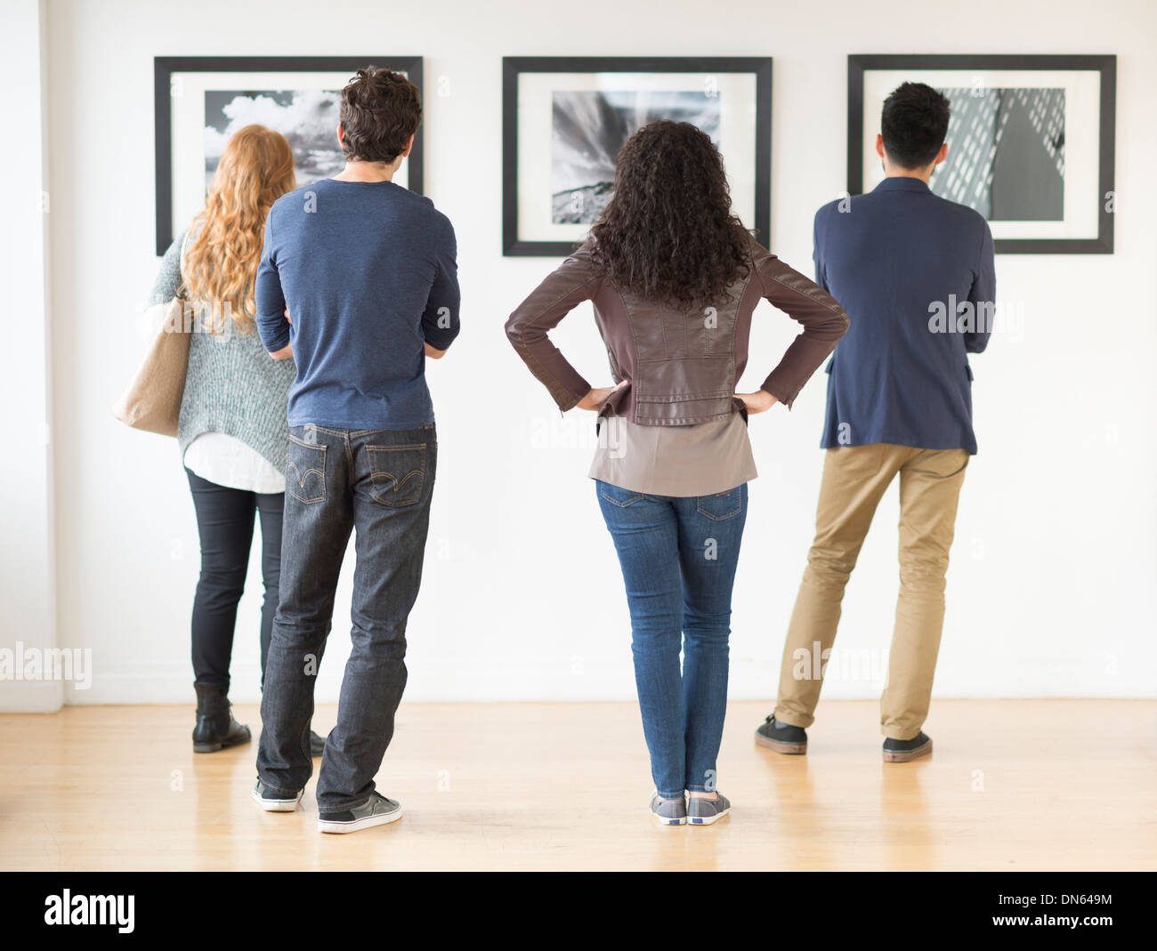 Couples admiring art in gallery Stock Photo