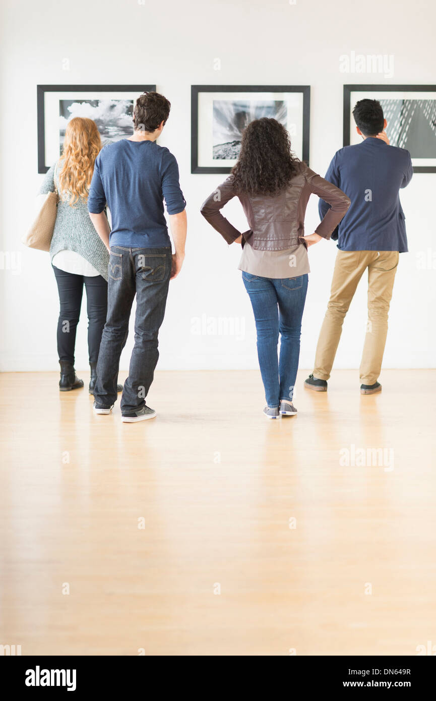 People admiring art in gallery Stock Photo