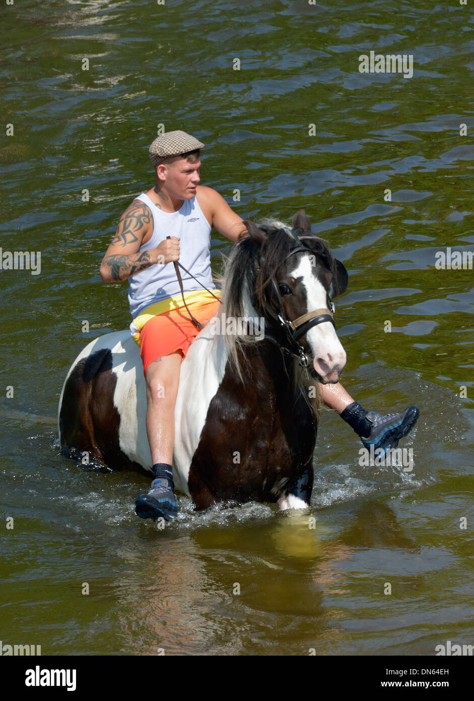 Gypsy traveller riding horse in River Eden. Appleby Horse Fair, Appleby-in-Westmorland, Cumbria, England, United Kingdom, Europe Stock Photo