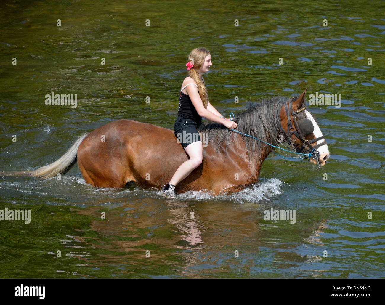 Gypsy traveller girl riding horse in River Eden. Appleby Horse Fair, Appleby-in-Westmorland, Cumbria, England, United Kingdom. Stock Photo