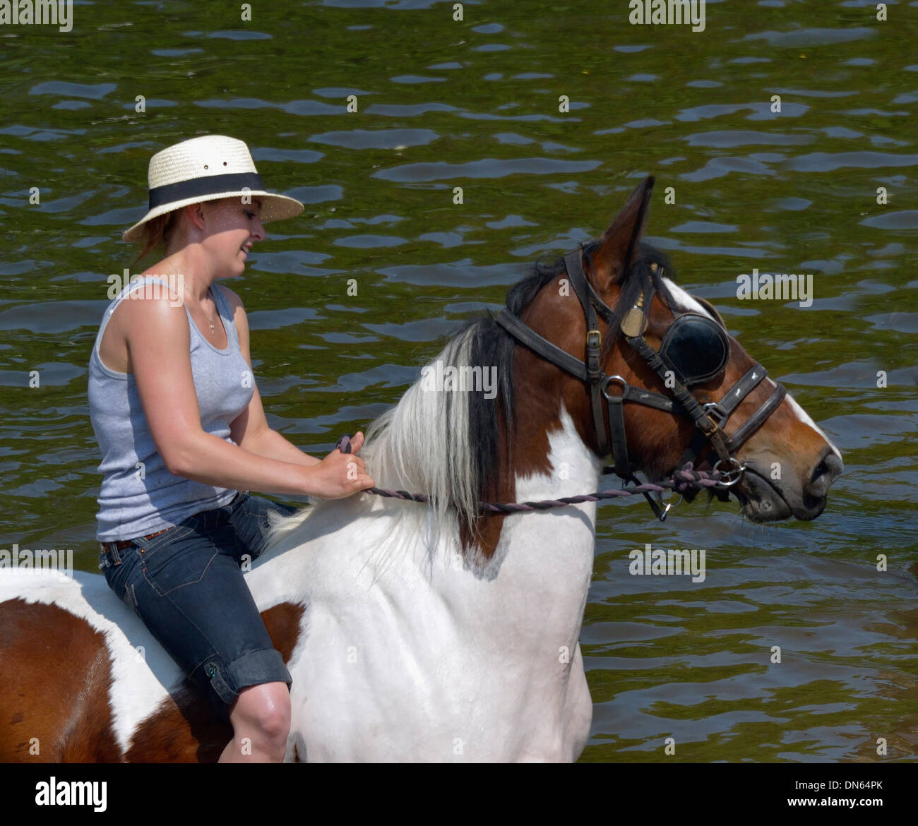 Gypsy traveller girl riding horse in River Eden. Appleby Horse Fair, Appleby-in-Westmorland, Cumbria, England, United Kingdom. Stock Photo