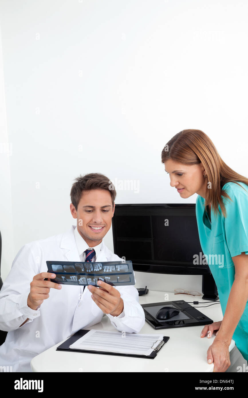 Dentist Analyzing X-Ray With Assistant Stock Photo