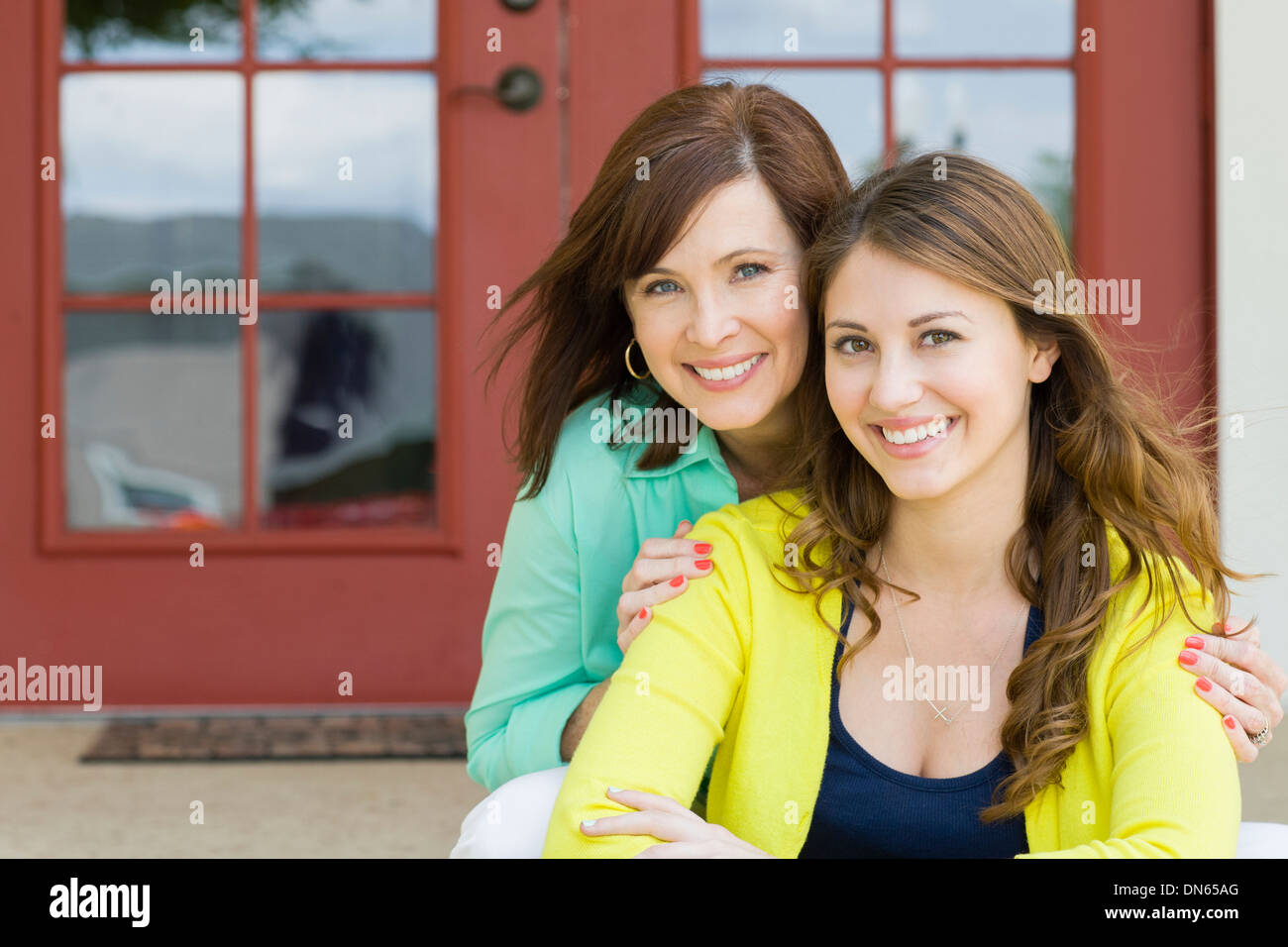 Caucasian mother and daughter smiling outdoors Stock Photo