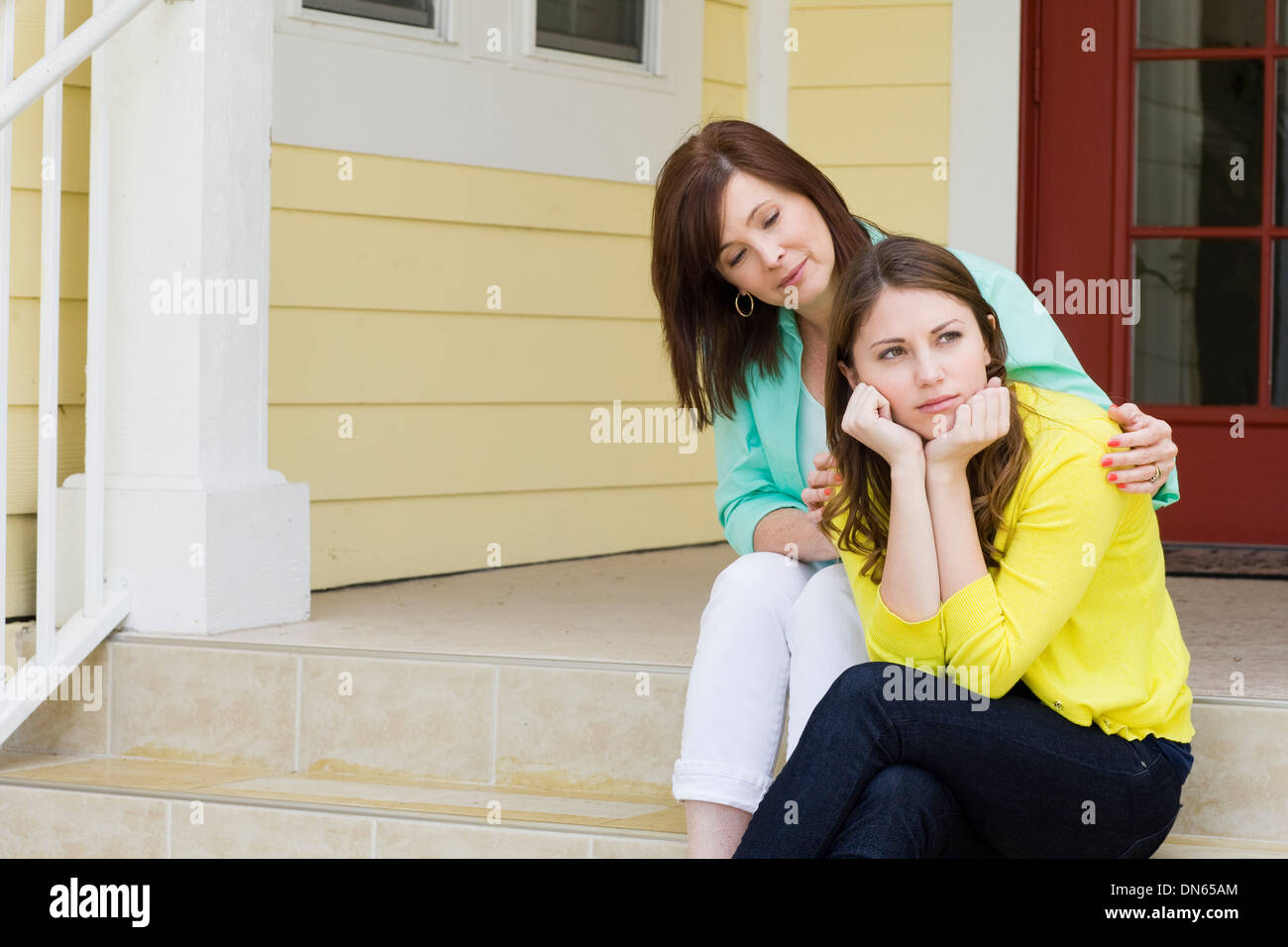 Caucasian mother comforting daughter outdoors Stock Photo
