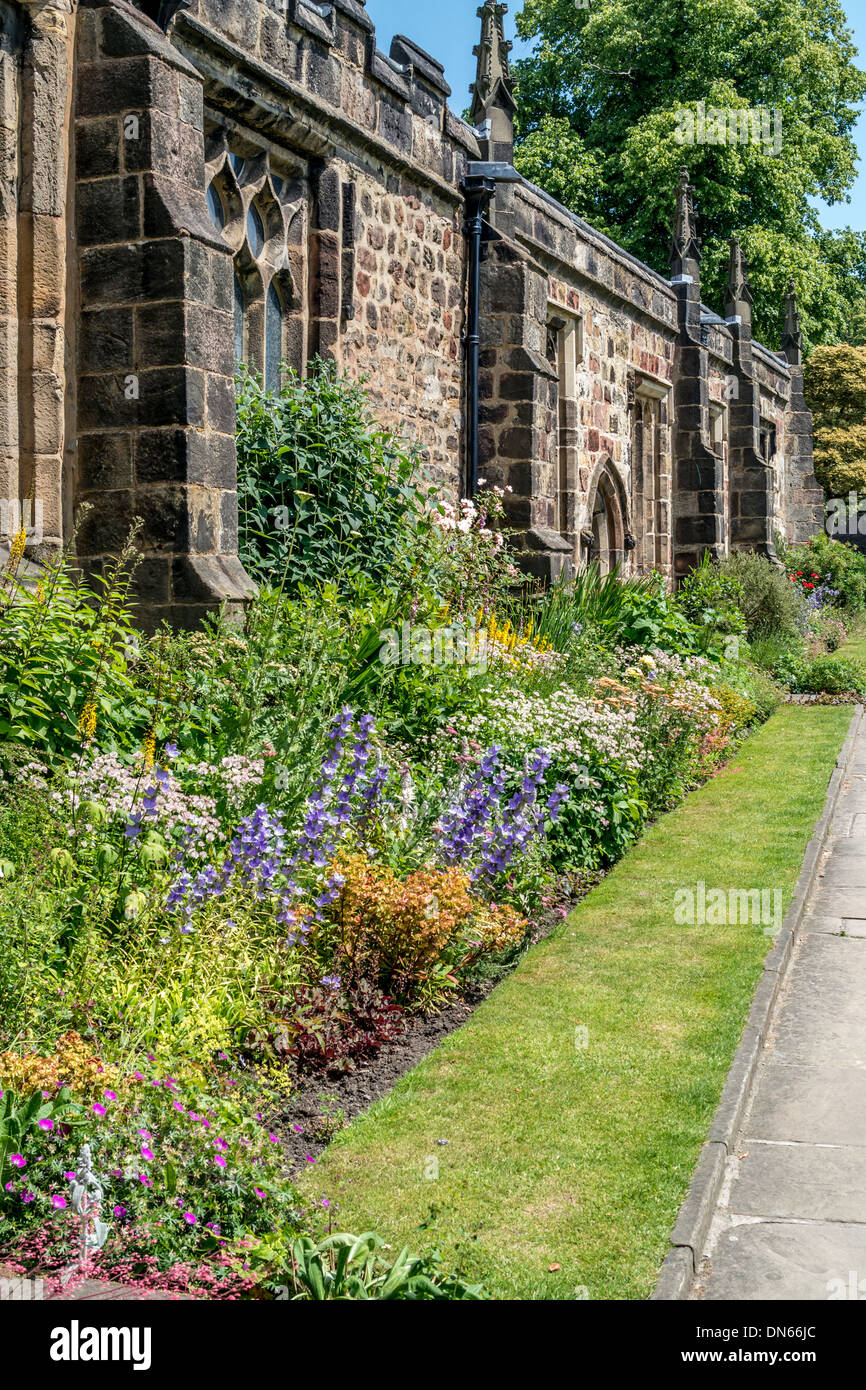 Side wall of a church with Flower beds and small path Stock Photo Alamy