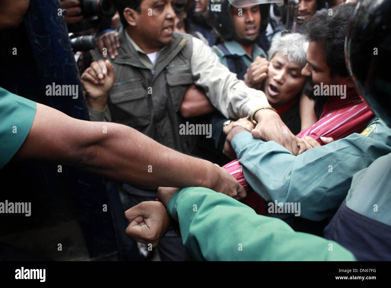 Dhaka, Bangladesh. 19th December 2013. Police trying to arrest IMRAN H Sarker, leader of Gnajagaran Monch. Police prevented the 'Ganajagaran Mancha' procession from entering the diplomatic enclave, their second march towards the Pakistan High Commission in Dhaka. Credit:  zakir hossain chowdhury zakir/Alamy Live News Stock Photo