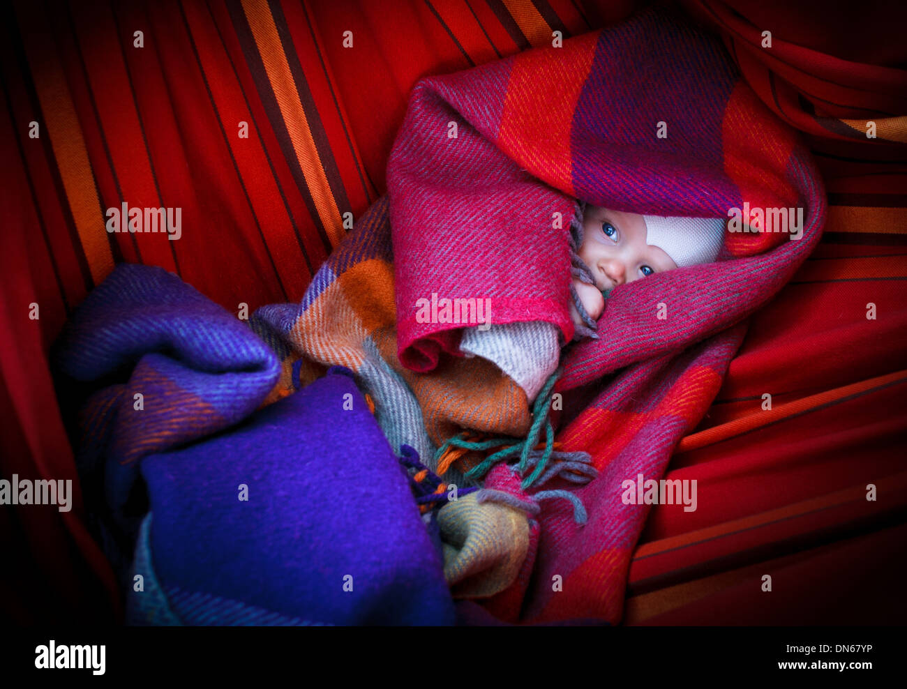 Little baby hanging on the hammock and lying under the blanket Stock