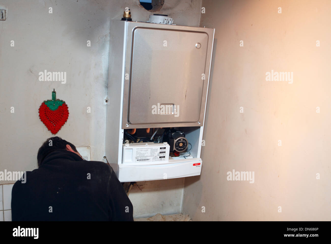 united kingdom london a plumber installing a combination gas boiler Stock Photo