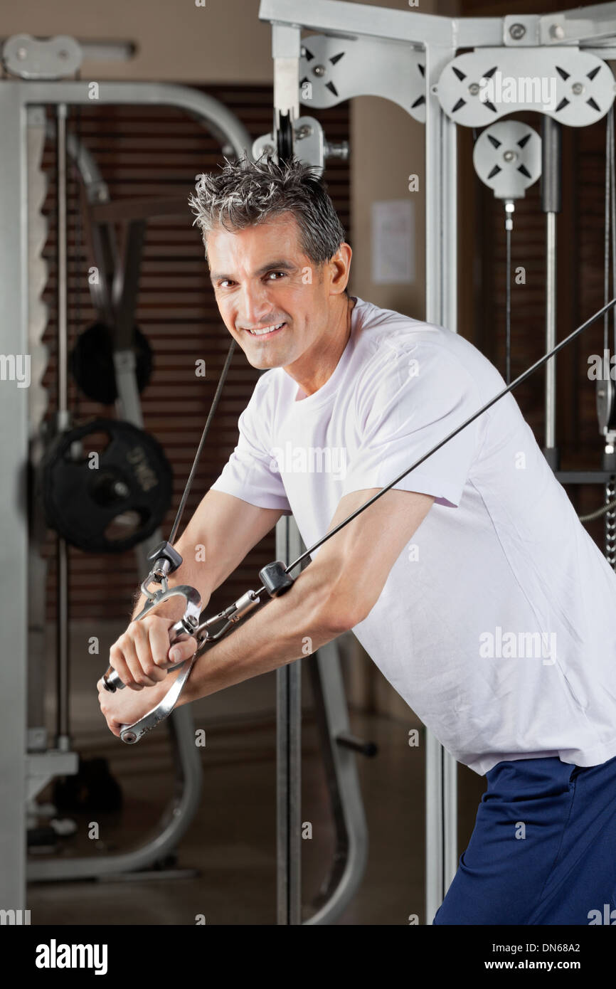 Mature Man Working Out In Fitness Center Stock Photo