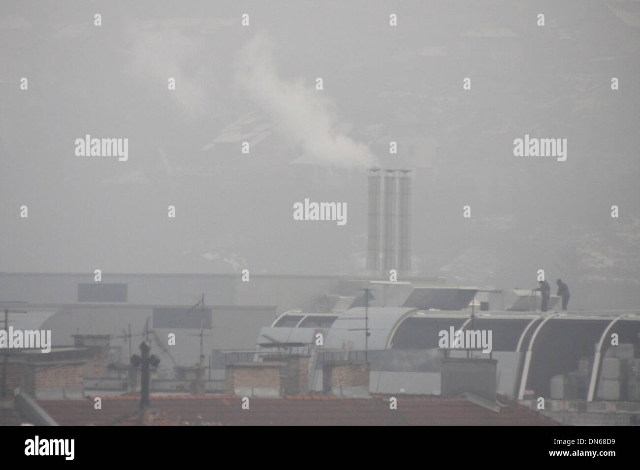 Sarajevo, Bosnia and Herzegovina. 19th Dec, 2013. Sweepers clean chimneys on roofs of buildings in Sarajevo, capital of Bosnia and Herzegovina, on Dec. 19, 2013. Air pollution in winter in Sarajevo became serious due to burning of coal and woods as well as the location of the city, which is surrounded by mountains. Credit:  Haris Memija/Xinhua/Alamy Live News Stock Photo