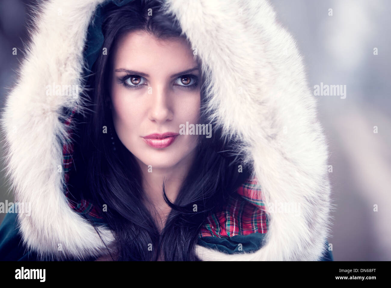 Beauty Portrait Of Woman Wearing A Fur Covered Hood On A Cold Winter