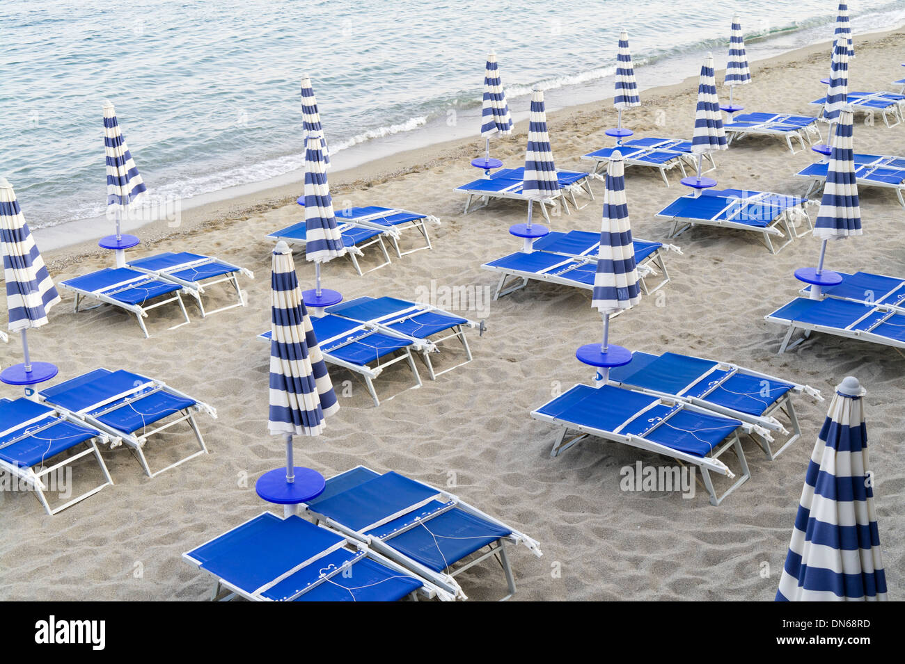 Sunloungers on empty lido beach folded up at the end of the day. Stock Photo