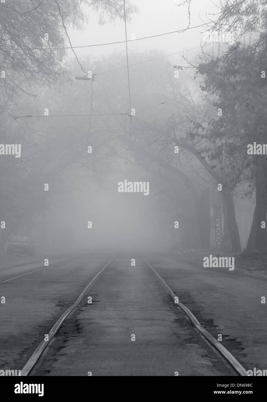 railway rails going to fog Stock Photo