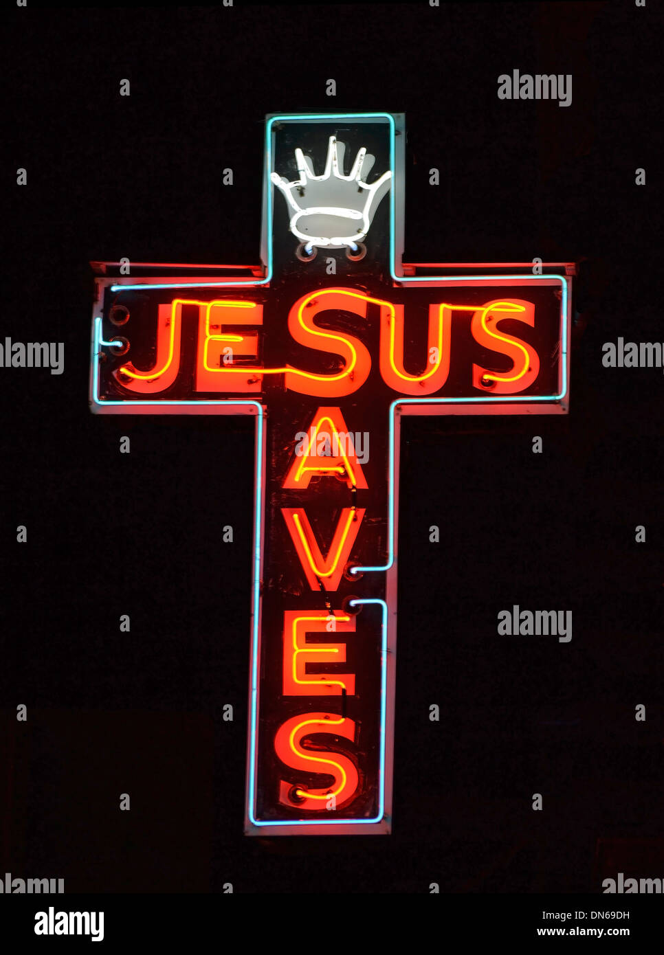 A red neon sign reading Jesus Saves Stock Photo