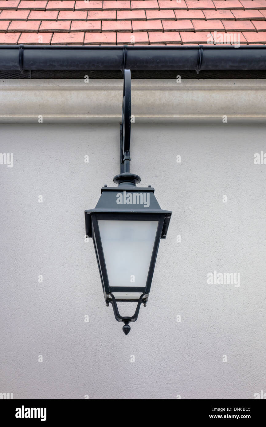 Old street lamp closeup on the wall Stock Photo