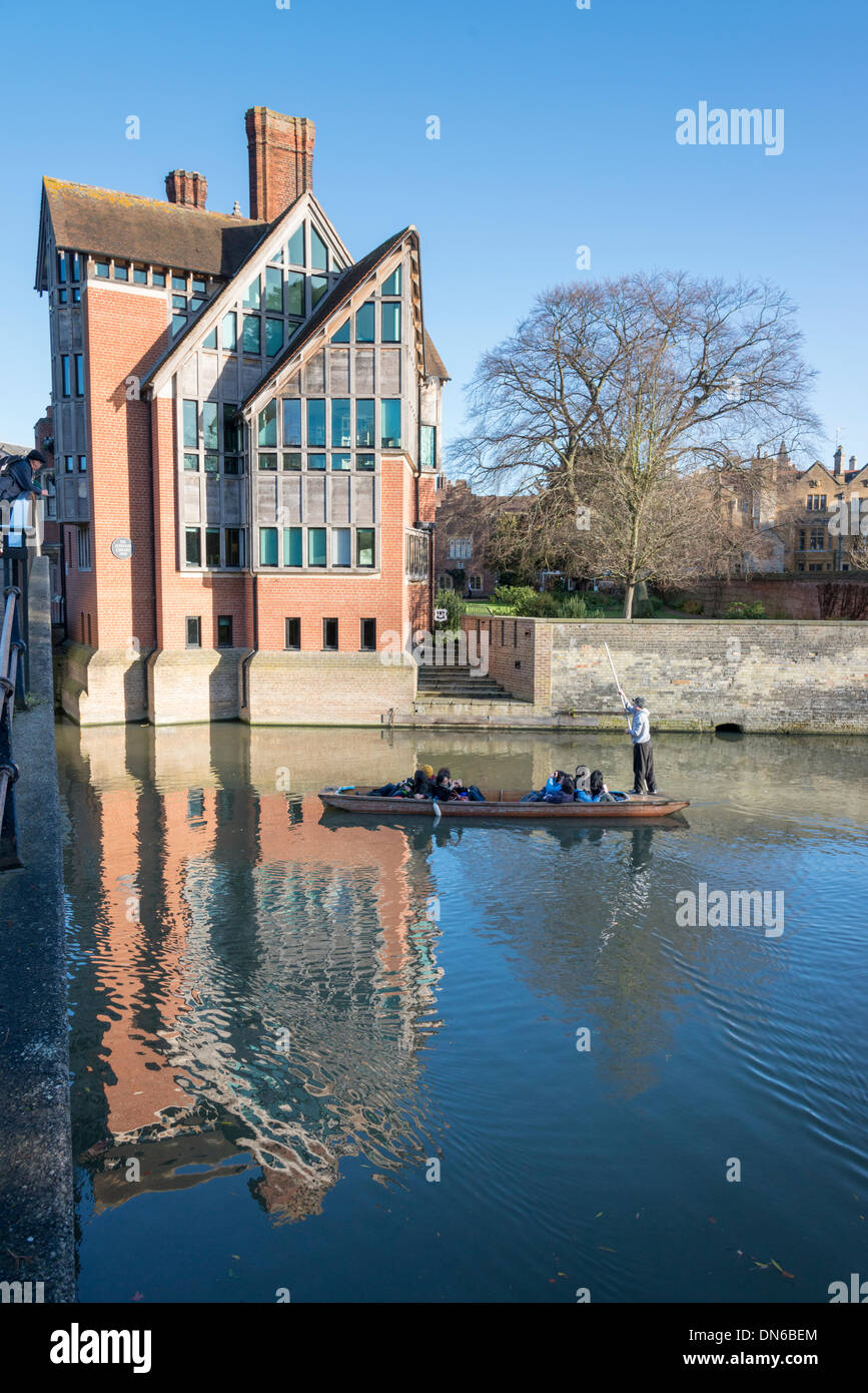 Cambridge, UK. 19th December 2013. Tourists enjoy punting in glorious winter sunshine past the Jerwood Library on the River Cam, Cambridge UK 19th December 2013. There was a cloudless sky during the day with strong sun illuminating the famous 'Backs' of the University buildings and river.  The Jerwood Library is part of Trinity Hall. Credit Julian Eales/Alamy Live News Stock Photo