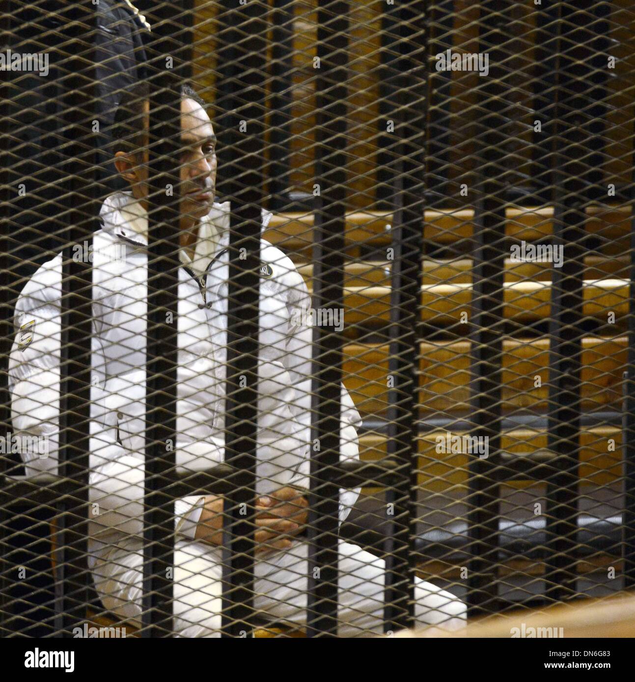 Cairo, Egypt. 19th Dec, 2013. Gamal Mubarak, son of former Egyptian leader Hosni Mubarak, sits inside the defendant's cage at a court in Cairo, Egypt, Dec. 19, 2013. An Egyptian court on Thursday ordered to acquit Mubarak's two sons Alaa and Gamal, and former prime minister Ahmed Shafiq, who were charged of misuse of public funds, Middle East News Agency reported. Credit:  Ahmed Omar/Xinhua/Alamy Live News Stock Photo