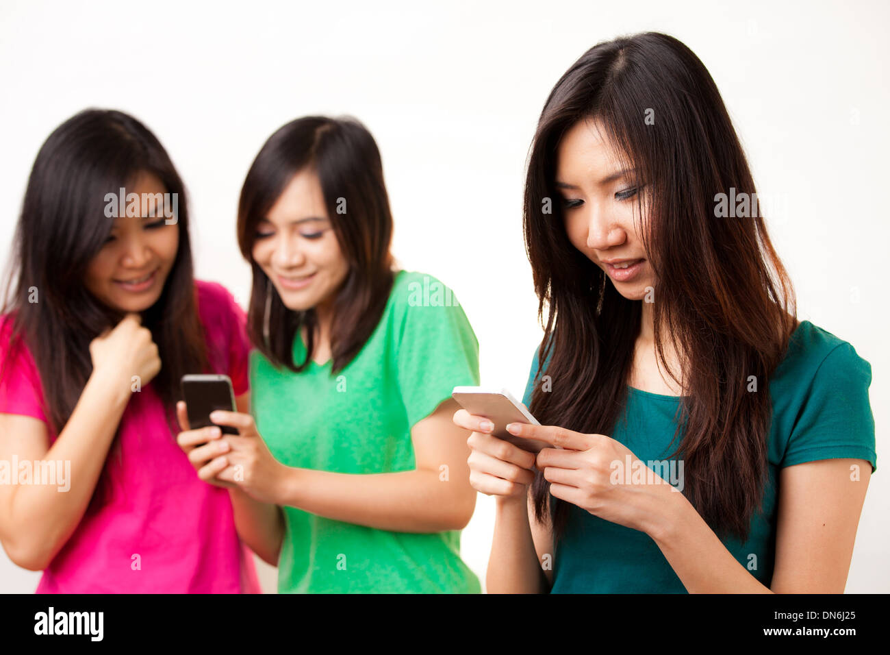 Group of Asian people enjoy their phone Stock Photo