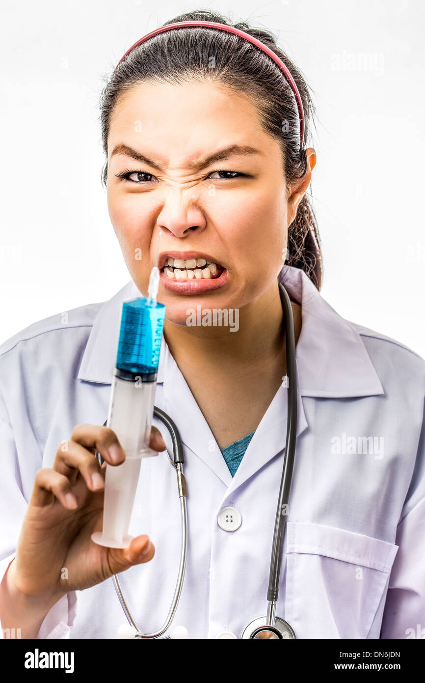 Angry crazy asian doctor with a syringe Stock Photo