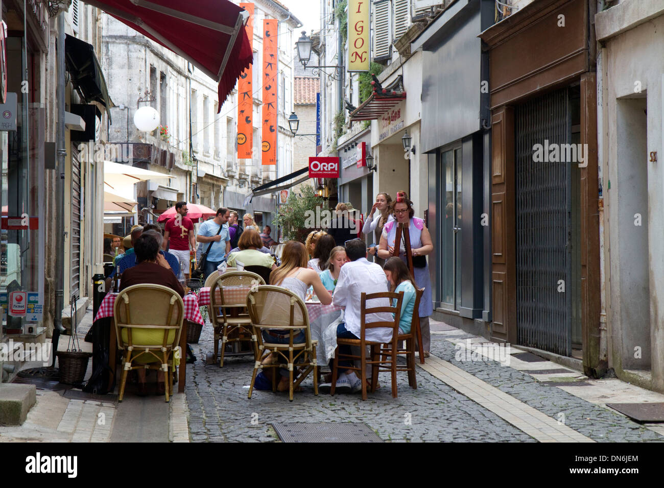 People sit at an outdoor cafe at Angouleme in southwestern France. Stock Photo