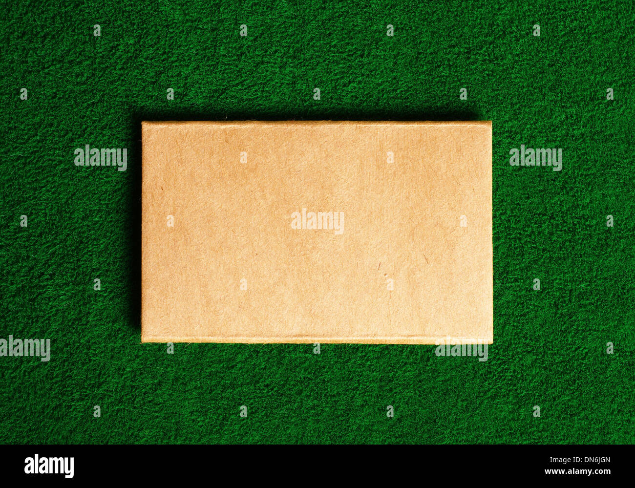cardboard note on green grass background Stock Photo - Alamy