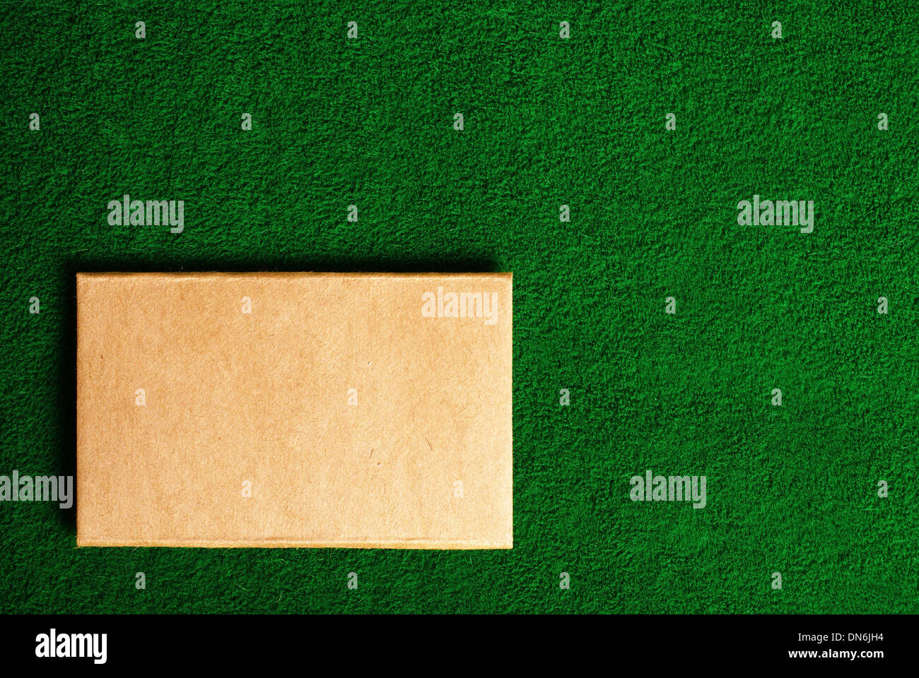 cardboard note on green grass background Stock Photo