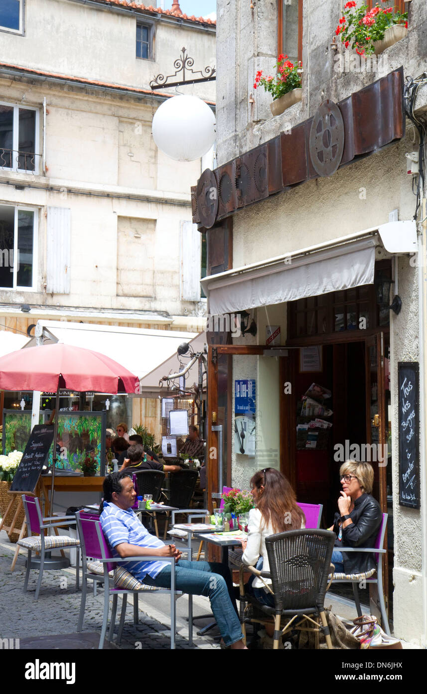 People sit at an outdoor cafe at Angouleme in southwestern France. Stock Photo