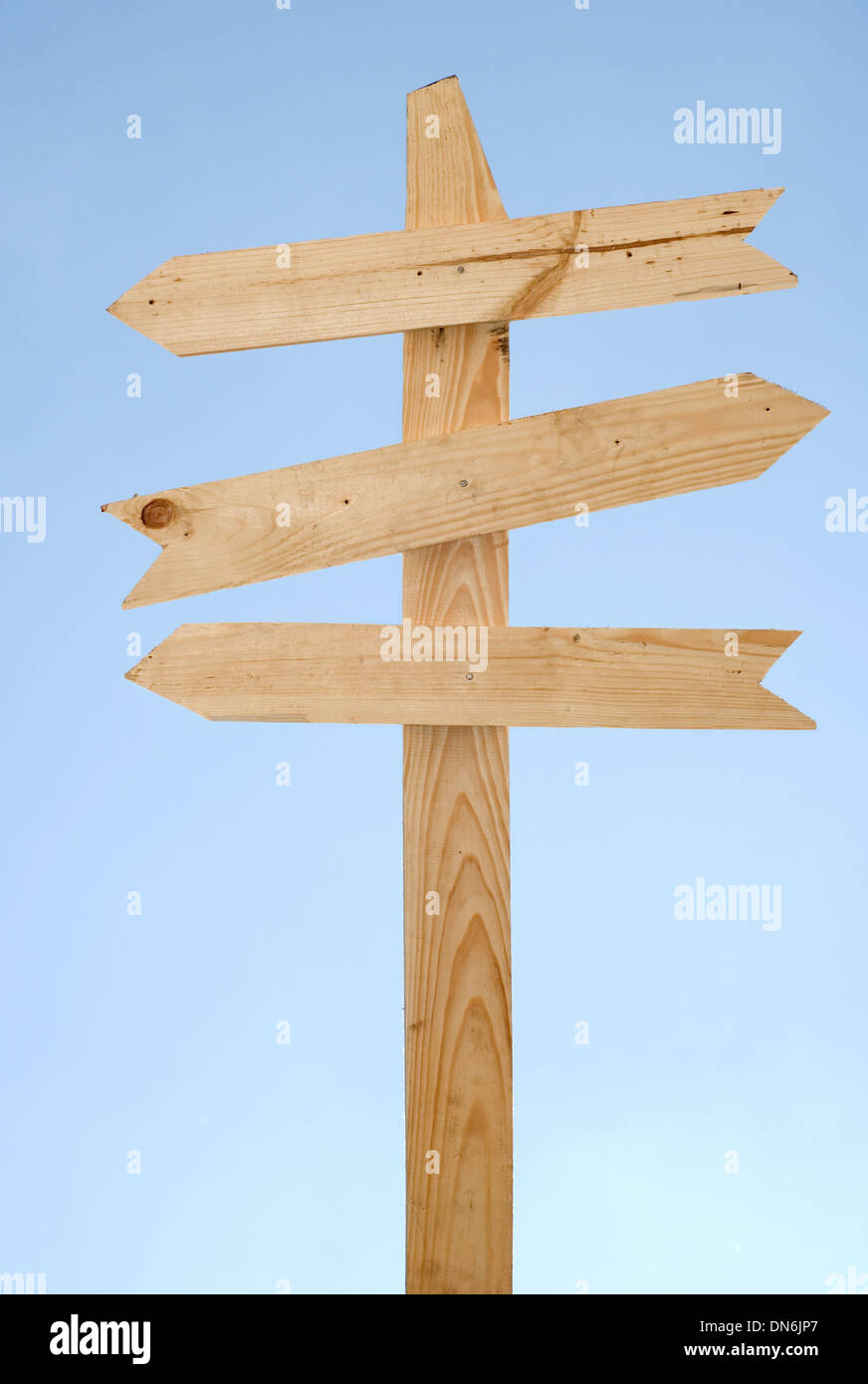 Blank wooden direction signpost against a blue sky Stock Photo