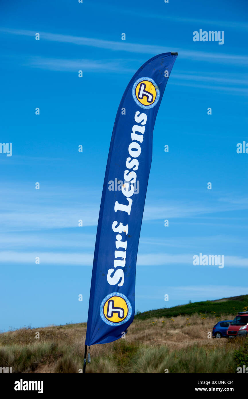 Surf Lessons banner sign against bright blue sky Stock Photo