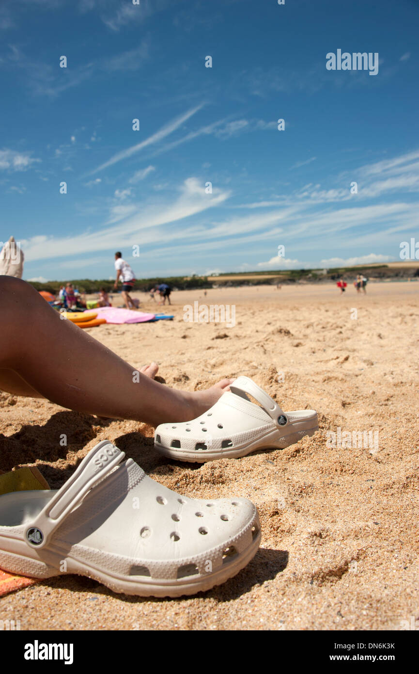 Sandals crocs on sunny sandy beach summer dreaming Stock Photo - Alamy