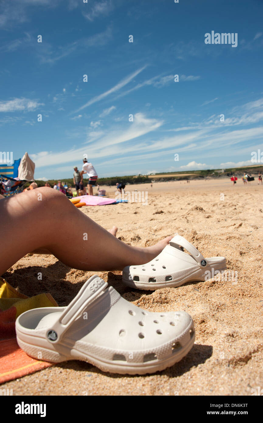 Sunbathers view of hot sunny sand beach blue sky Stock Photo