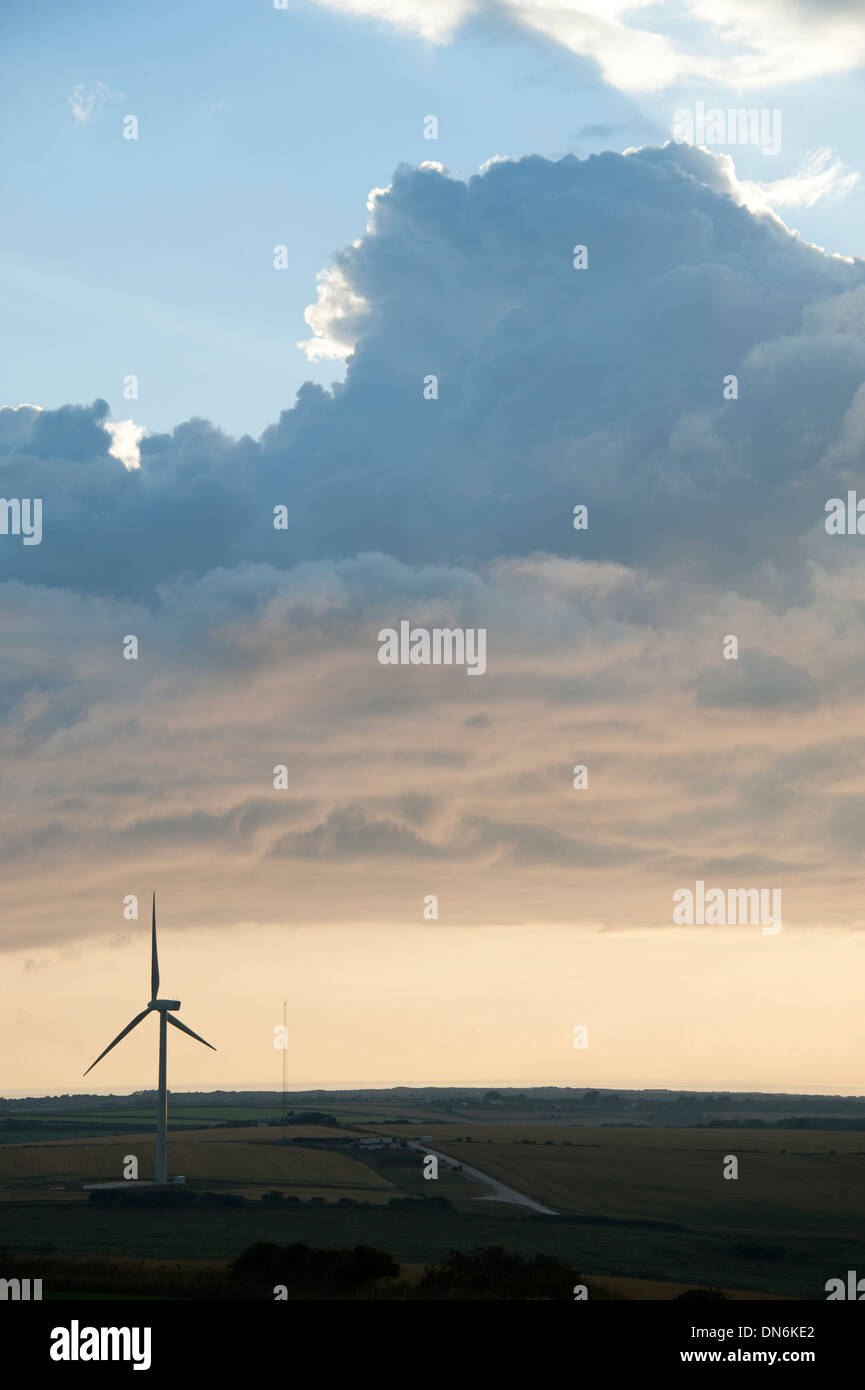 Sunset clouds sky over windfarm wind turbines storm approaching Stock Photo