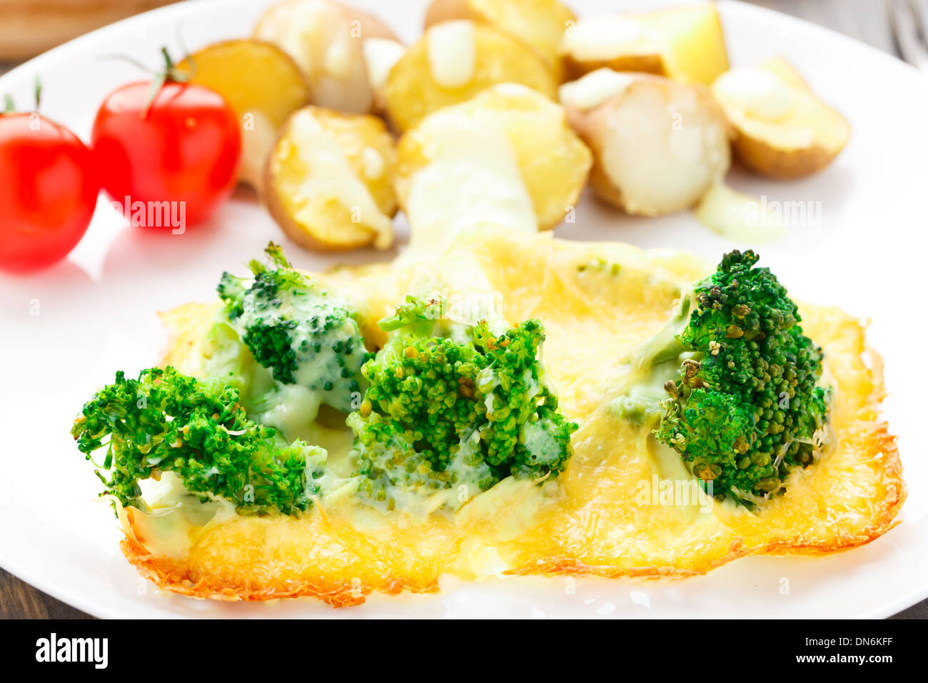 Broccoli gratin with cheese and baked potato Stock Photo Alamy