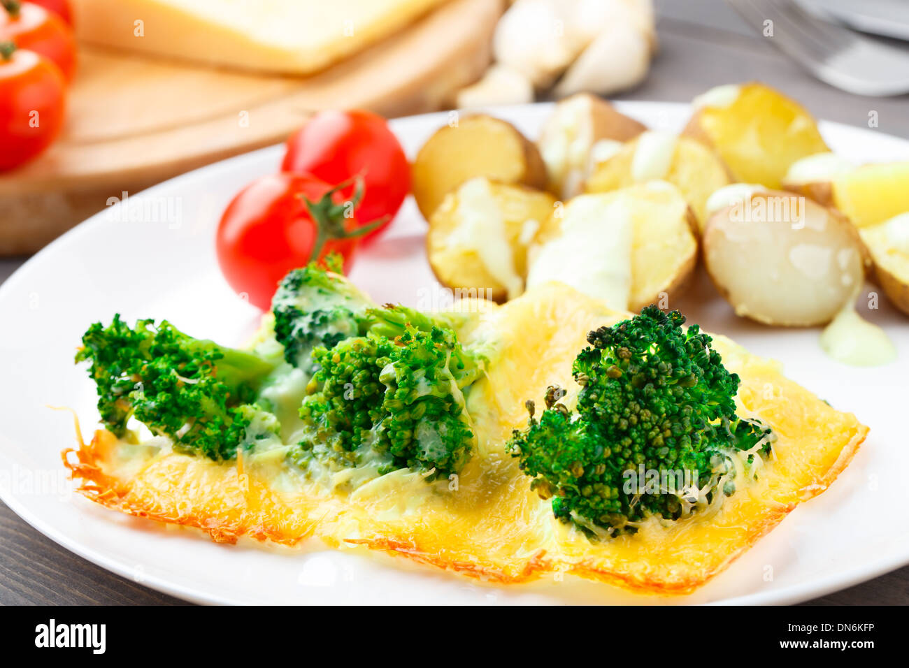 Broccoli gratin with cheese and baked potato Stock Photo Alamy