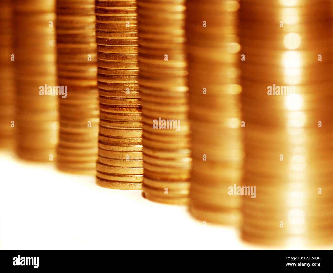 Column of golden coins isolated on white. Stock Photo