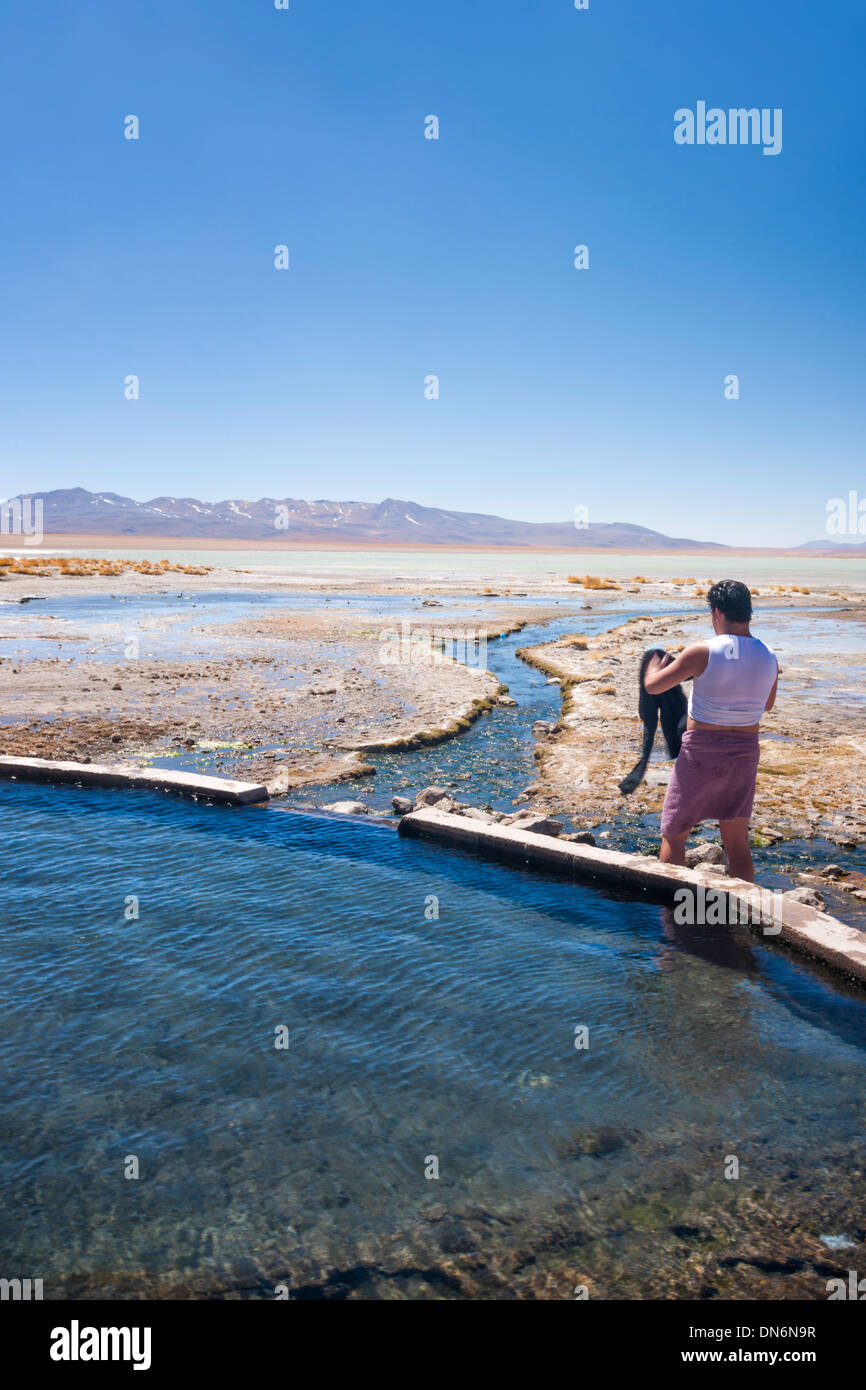 Man standing beside Laguna Polques hot springs near Chilean border Stock Photo