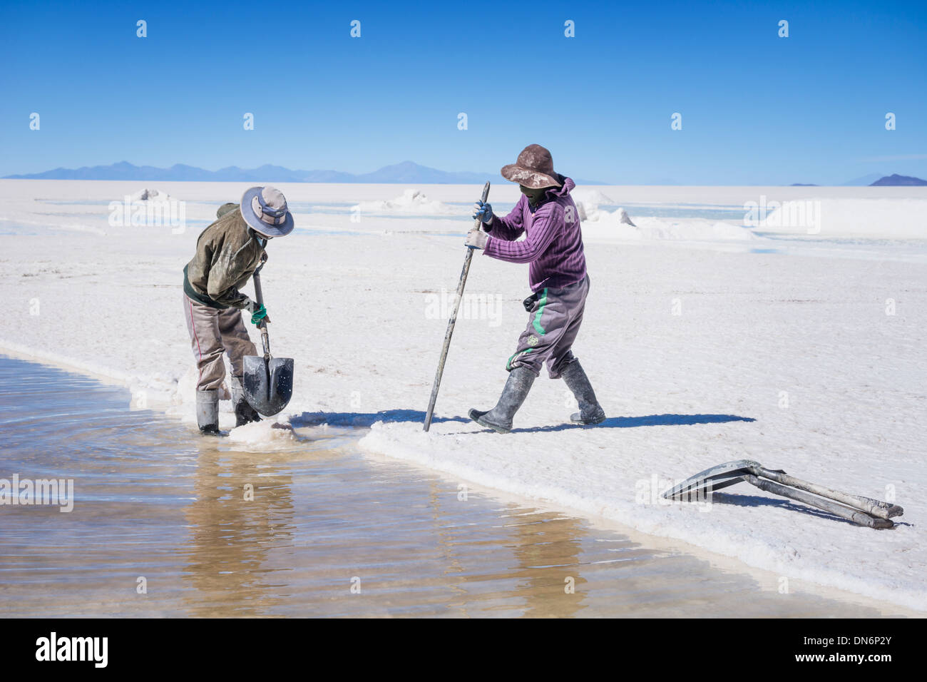 Bolivian salt miners extract salt from Uyuni salt flats, Salar de Uyuni, Bolivia, South America Stock Photo