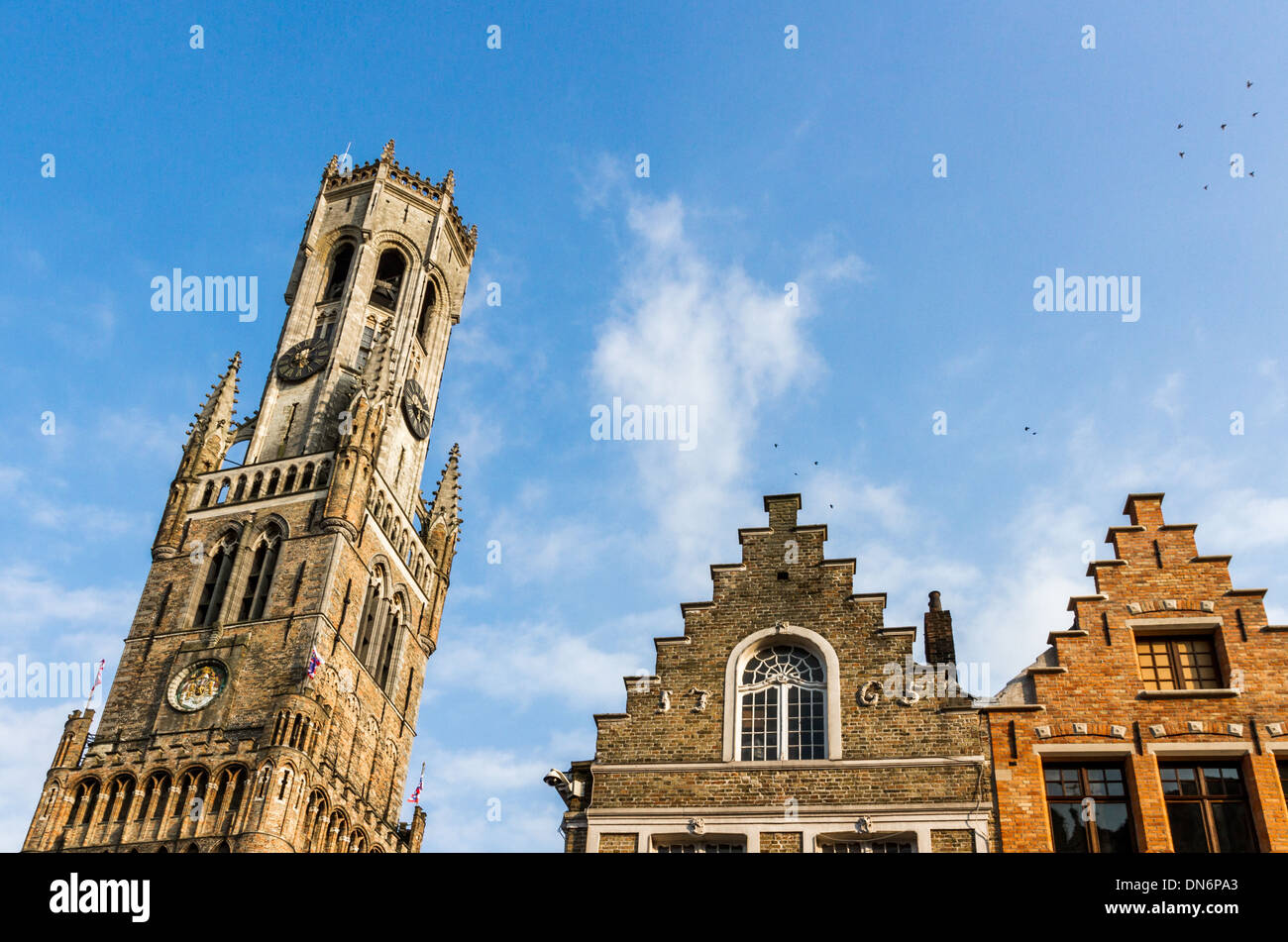 View on the Belfort of Bruges next to medieval Corbie Step Buildings Stock Photo
