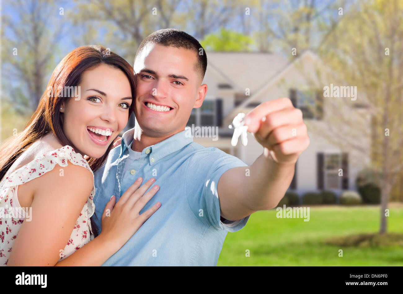 Mixed Race Excited Military Couple In Front of New Home Showing Off ...
