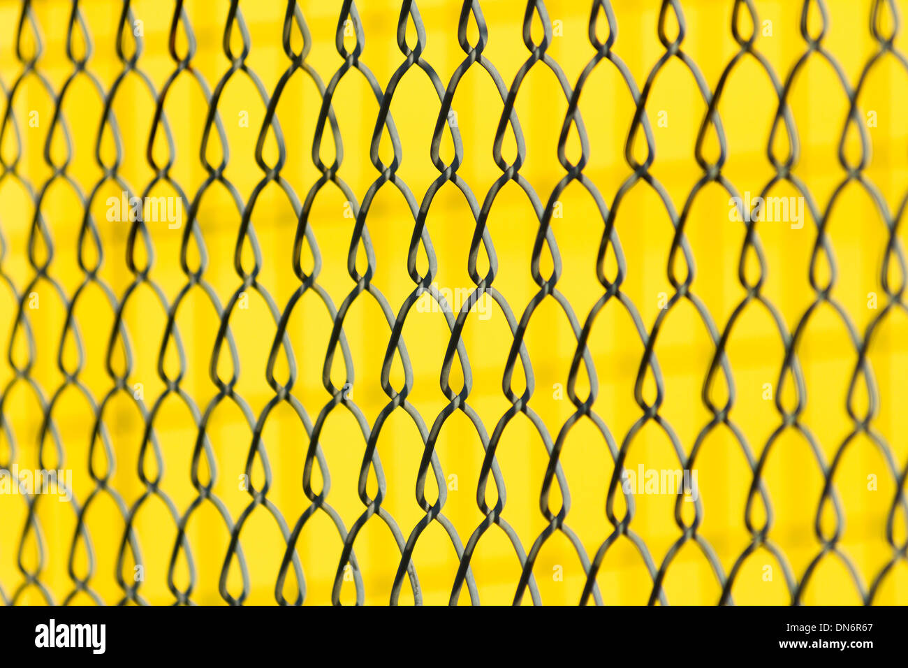 metal Mesh with yellow background Stock Photo