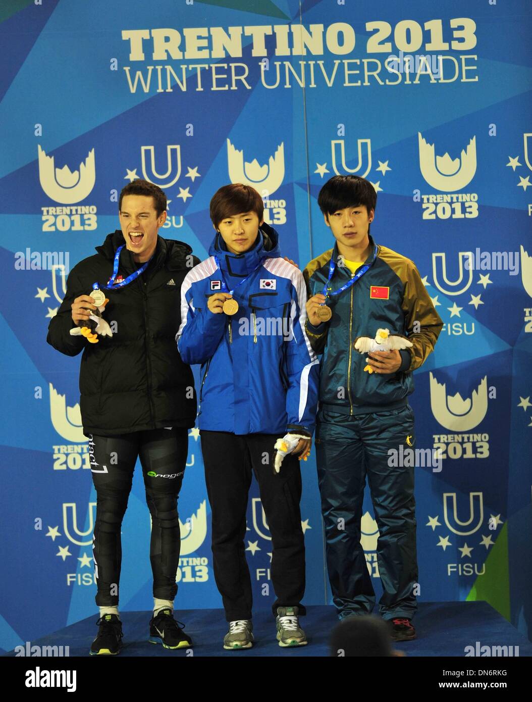Trentino, Italy. 19th Dec, 2013. Gold medallist South Korea's Lee Hyobeen (C), silver medallist Canada's Patrick Robert Pippy Duffy (L) and China's Shi Jingnan pose for photos during the awarding ceremony of the men's short track 500m at the 26th Winter Universiade in Trentino, Italy, Dec. 19, 2013. Credit:  He Changshan/Xinhua/Alamy Live News Stock Photo