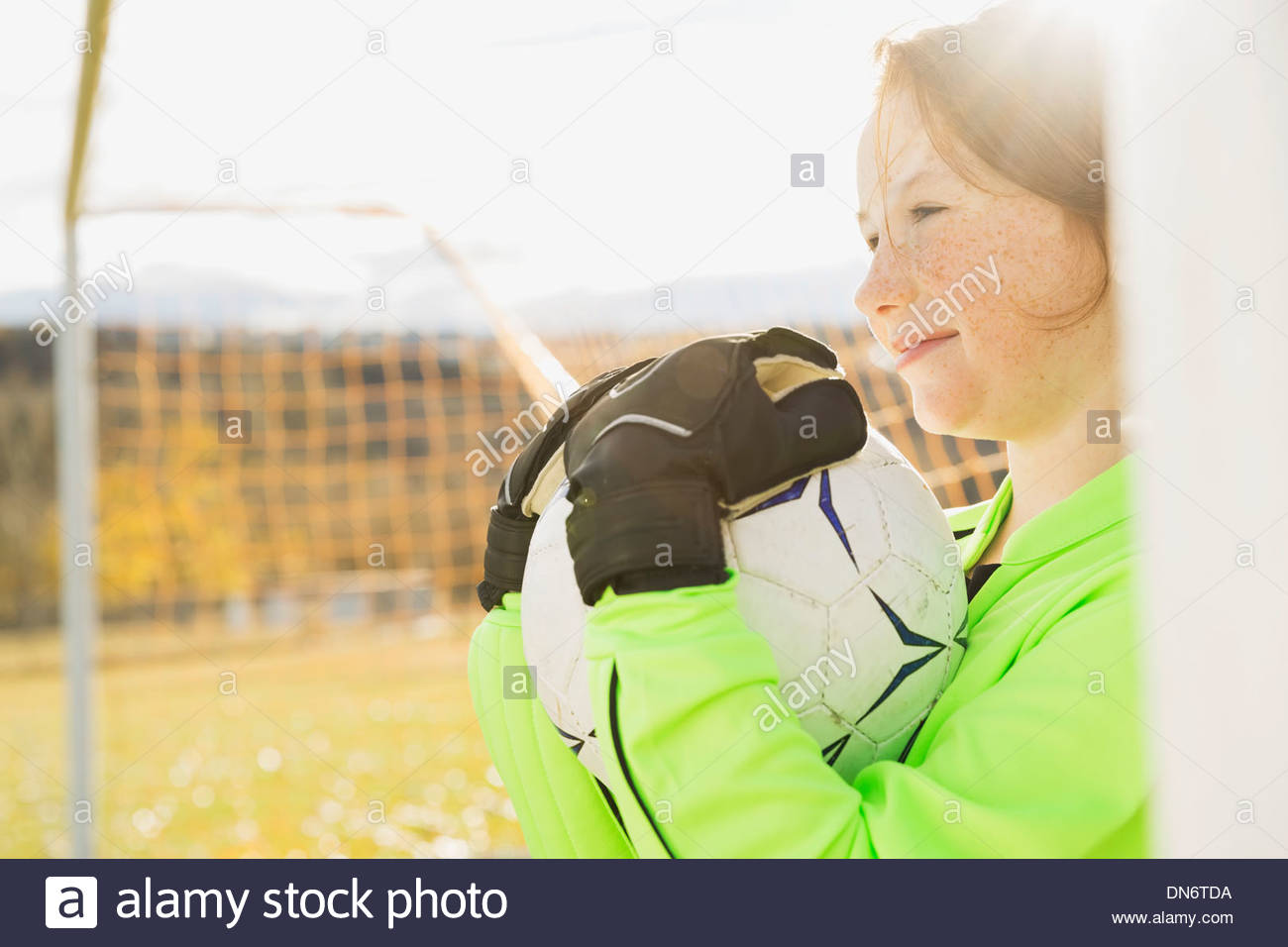 Goalie holding ball on soccer field Stock Photo Alamy