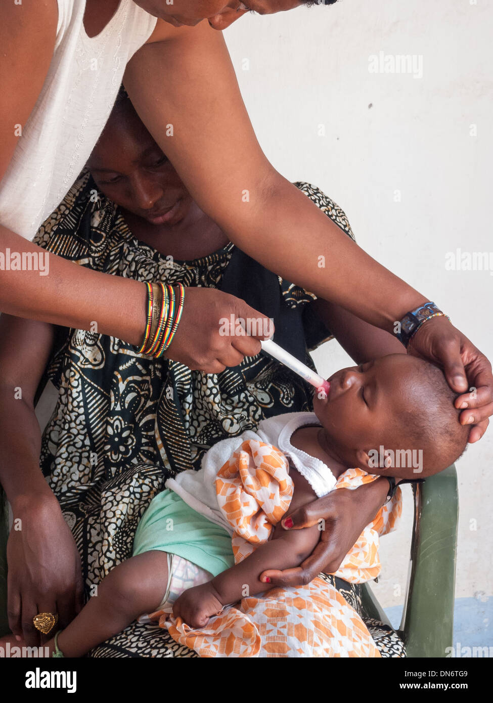 Nurse giving vaccine to a toddler at the Medical facility in Juffureh, Stock Photo