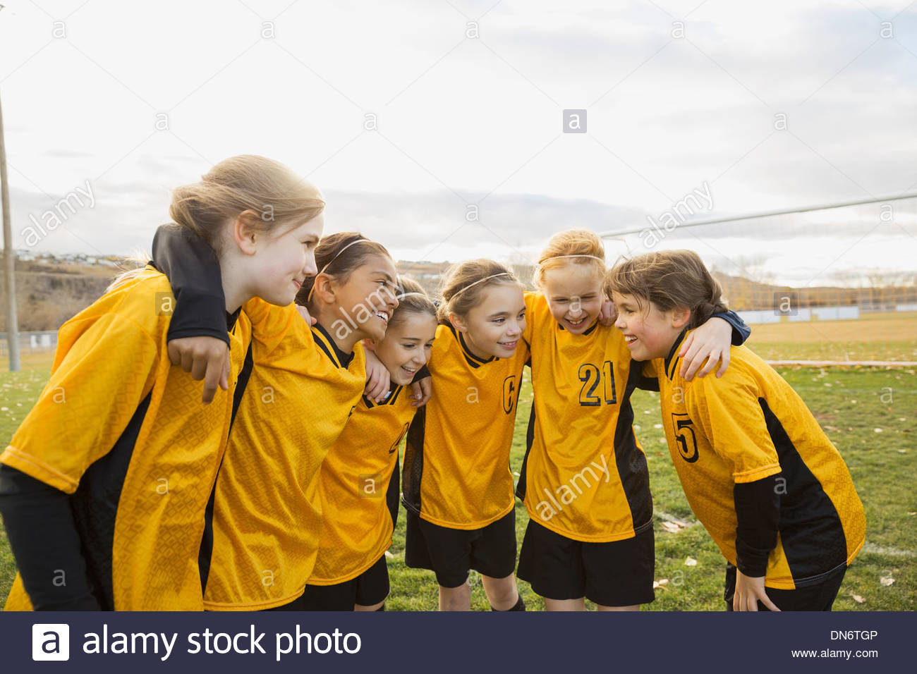 Soccer players discussion strategy on field Stock Photo - Alamy