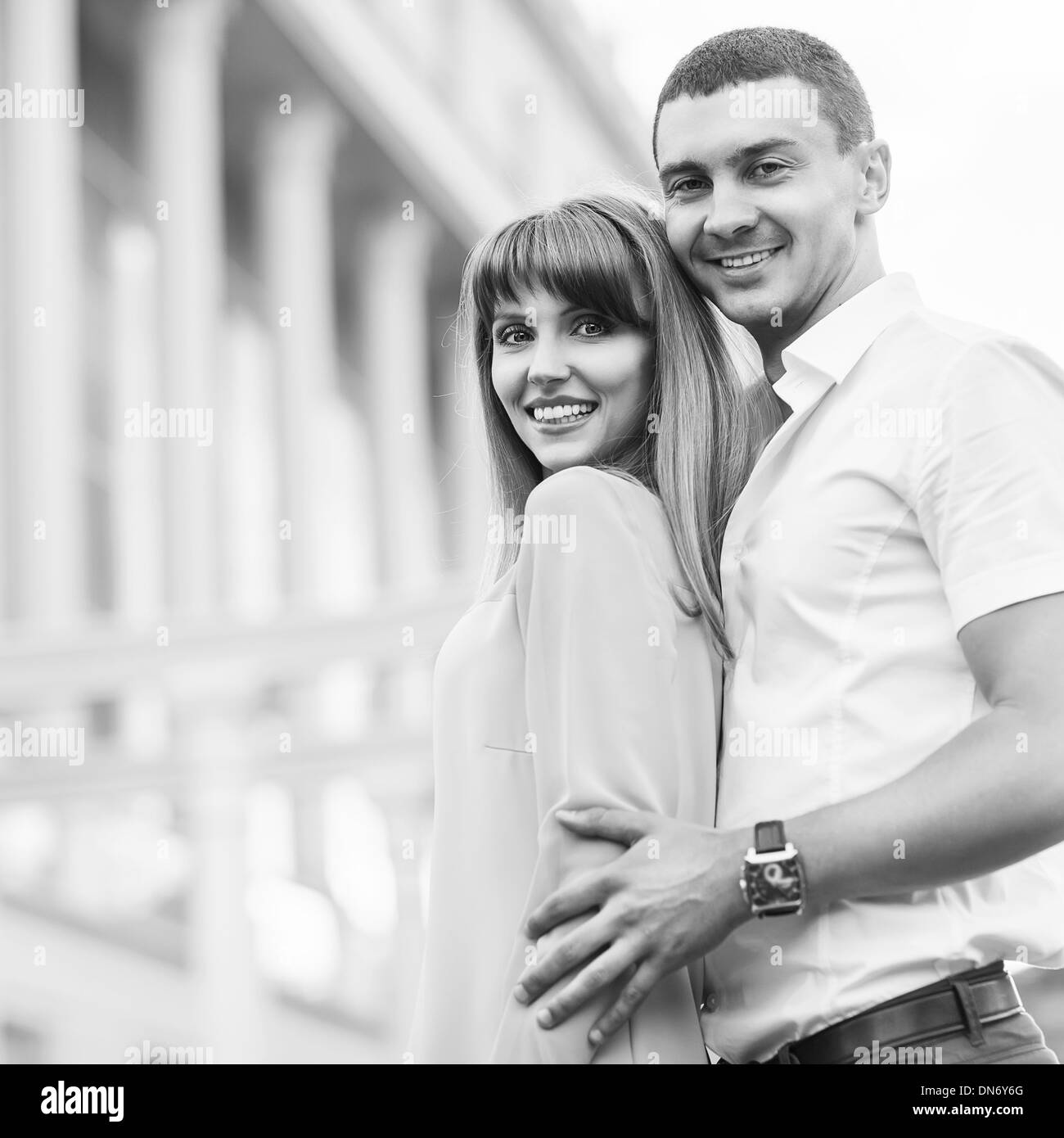 Couple happiness fun. Interracial young couple embracing laughing on