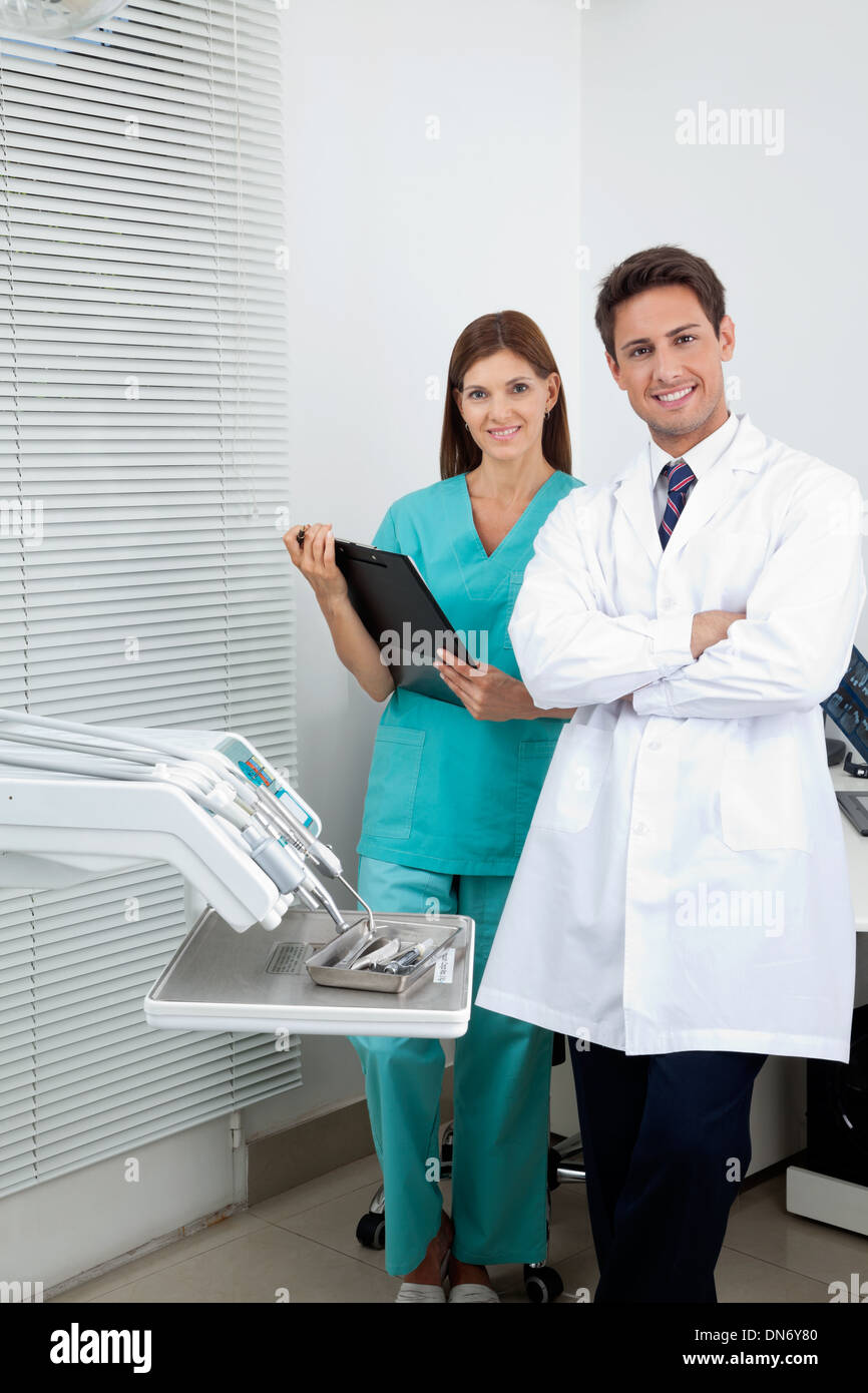 Dentist And Female Assistant In Clinic Stock Photo