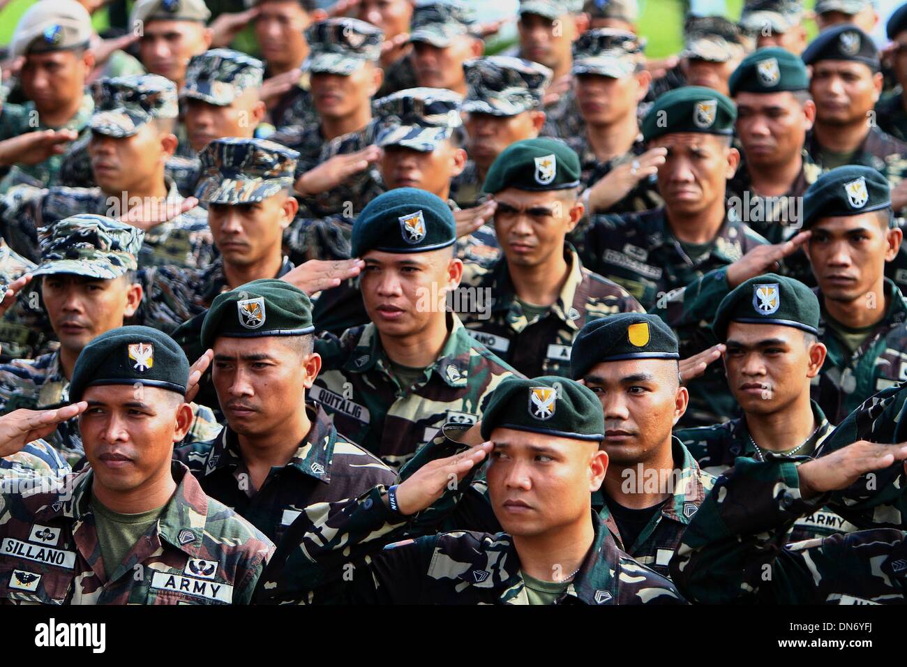 Quezon City, Philippines. 20th Dec, 2013. Soldiers from the Armed Forces of the Philippines (AFP) salute during the celebration of the 78th anniversary of AFP at Camp Aguinaldo in Quezon City, the Philippines, Dec. 20, 2013. Credit:  Rouelle Umali/Xinhua/Alamy Live News Stock Photo