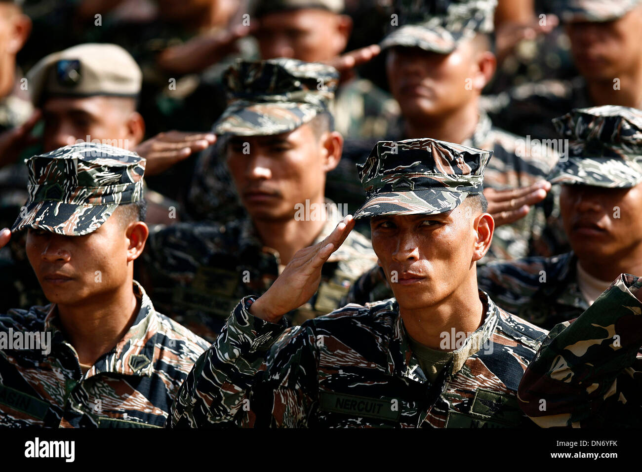 Quezon City, Philippines. 20th Dec, 2013. Soldiers from the Armed Forces of the Philippines (AFP) salute during the celebration of the 78th anniversary of AFP at Camp Aguinaldo in Quezon City, the Philippines, Dec. 20, 2013. Credit:  Rouelle Umali/Xinhua/Alamy Live News Stock Photo