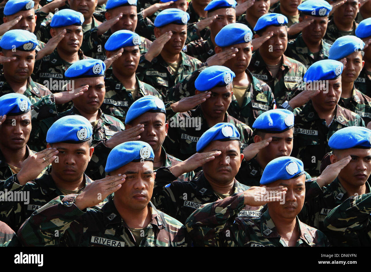 Quezon City, Philippines. 20th Dec, 2013. Soldiers from the UN Peacekeepers of the Armed Forces of the Philippines (AFP) salute during the celebration of the 78th anniversary of AFP at Camp Aguinaldo in Quezon City, the Philippines, Dec. 20, 2013. Credit:  Rouelle Umali/Xinhua/Alamy Live News Stock Photo