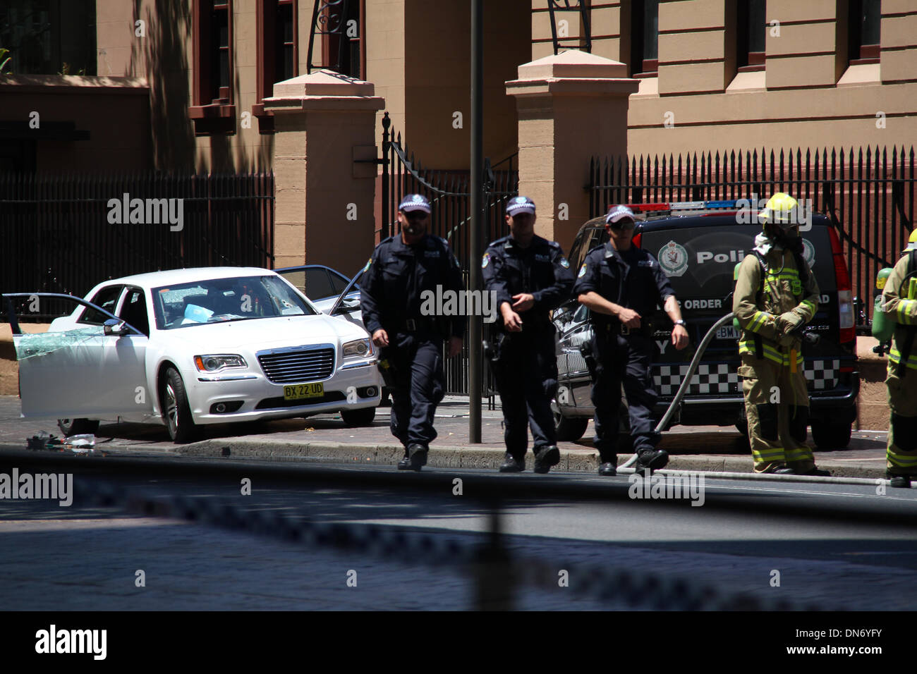 Macquarie Street, Sydney NSW 2000, Australia. 20 December 2013. Police and Fire & Rescue attend to the incident involving a man in a white car outside the NSW Parliament on Macquarie Street, Sydney. Copyright Credit:  2013 Richard Milnes/Alamy Live News Stock Photo